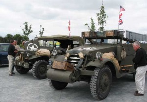 Normandie Tours 40/45 We met these guys in the parking lot before we went to Pointe du Hoc above. They offer tours to visit the historical D-Day sites in one of their restored army vehicles. You can book for an hour, a half-day or a full day tour. They also offer 7-day tours where they set up camp in Army tents. How cool is that? John could not pry himself away from talking trucks and parts.