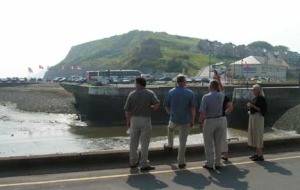 Port-en-Bessin. If you have watched the movie "The Longest Day", you will recognize this shot. The road on the left and the round tower are where the nuns walked down to help the soldiers in the hotel. This scene was shot here and they built the casino for the movie. Nothing of the casino is left now.