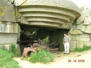 I was observing the damage to the gun from a charge that was placed inside the barrel and on the emplacement.