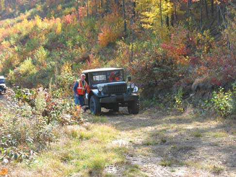 John F. and his M37 lost traction. Time to lock the hubs in! Then he made it up. A good laugh was had as I did not have to even engage the 4WD on my WC 58 to make it.